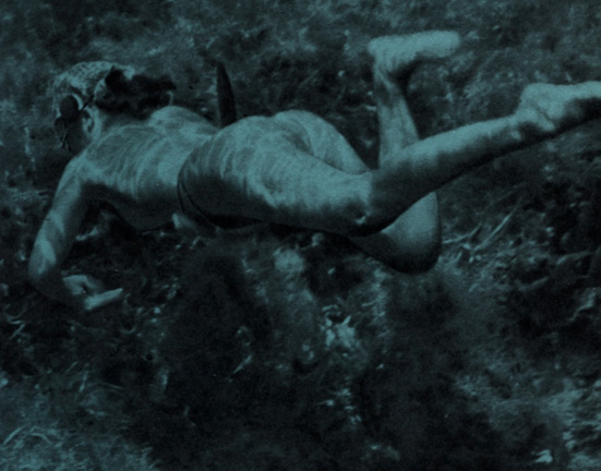 Naked underwater photo of shapely Asiatic women swimming in the sea as a mermaid