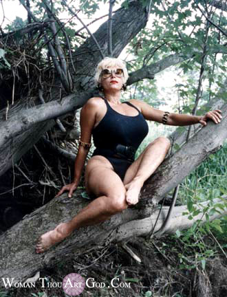 Muscular Voluptuous Woman Sitting On The Trunk Of Tree