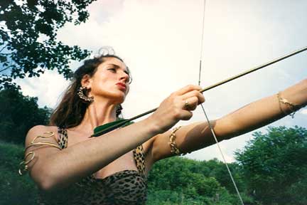 Amazon woman in leopard skin print with bow and arrow