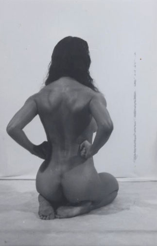 Nude Amazon woman from rear. Incredibly  muscular back flexing biceps and butt. Classy black white photo.