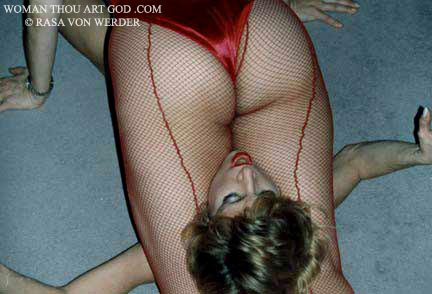 Butt view of legs clad in red fishnet stockings pinning blonde in scissor leg choke hold