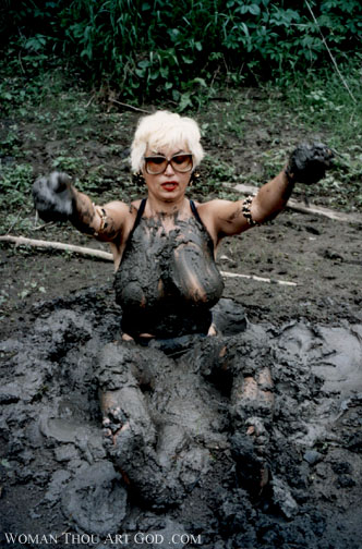 Bleached blonde in black top stuck in a pit of mud like quicksand